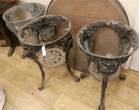 A set of three cast iron based circular tables, H.68cm